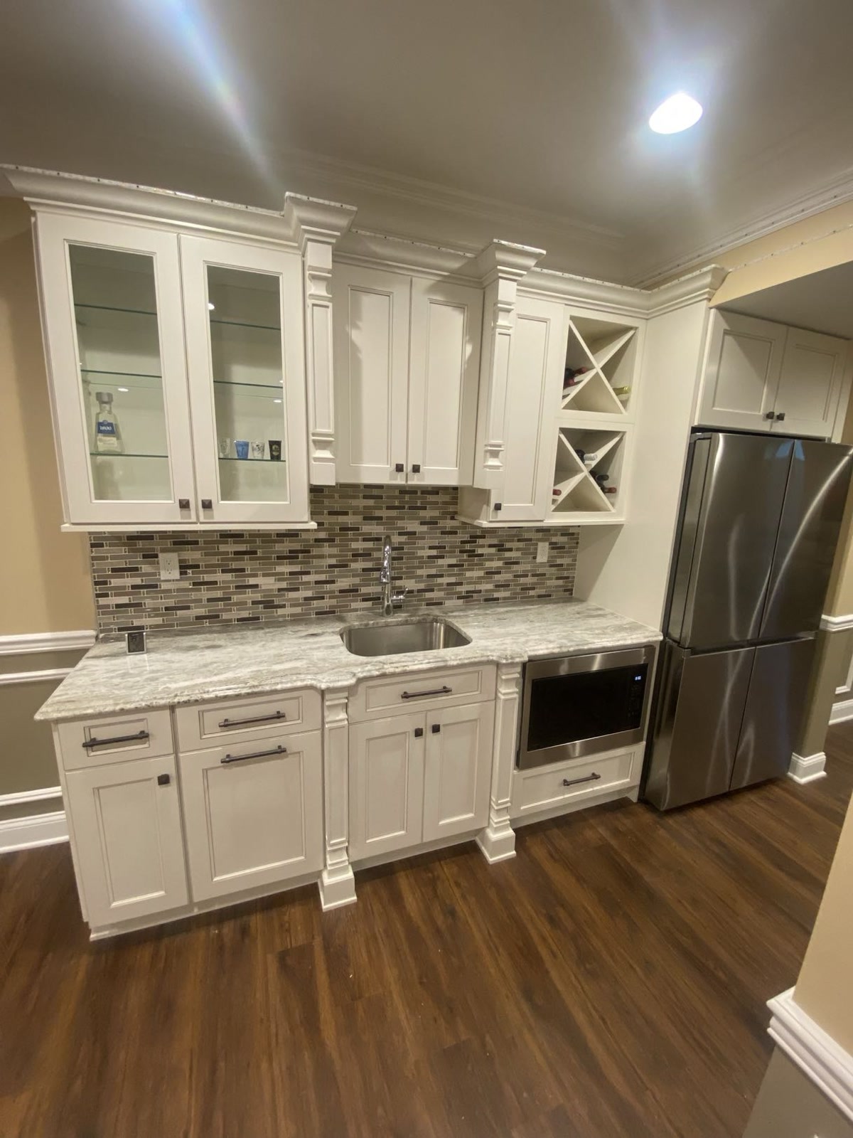 Basement kitchenette with custom cabinetry