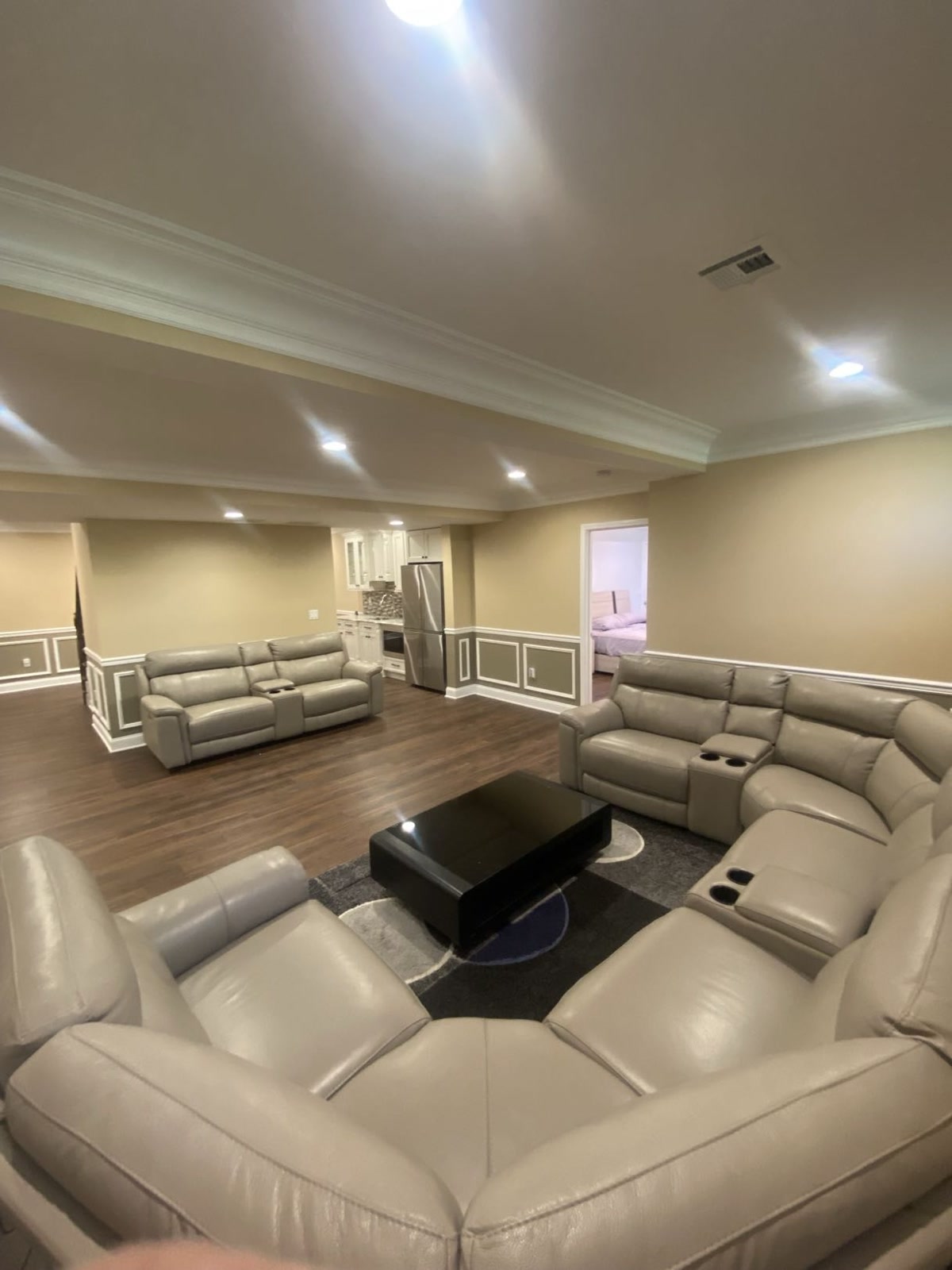 Finished basement living area with wainscoting