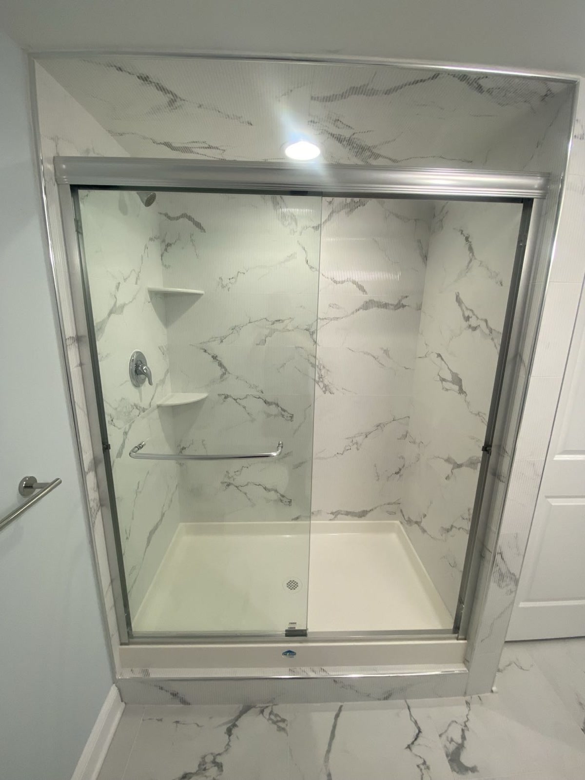 Basement walk-in shower with marble surround