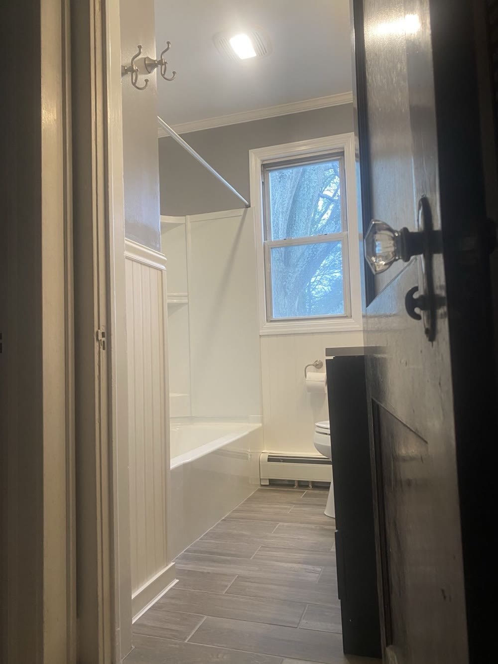 Finished bathroom with beadboard and tub
