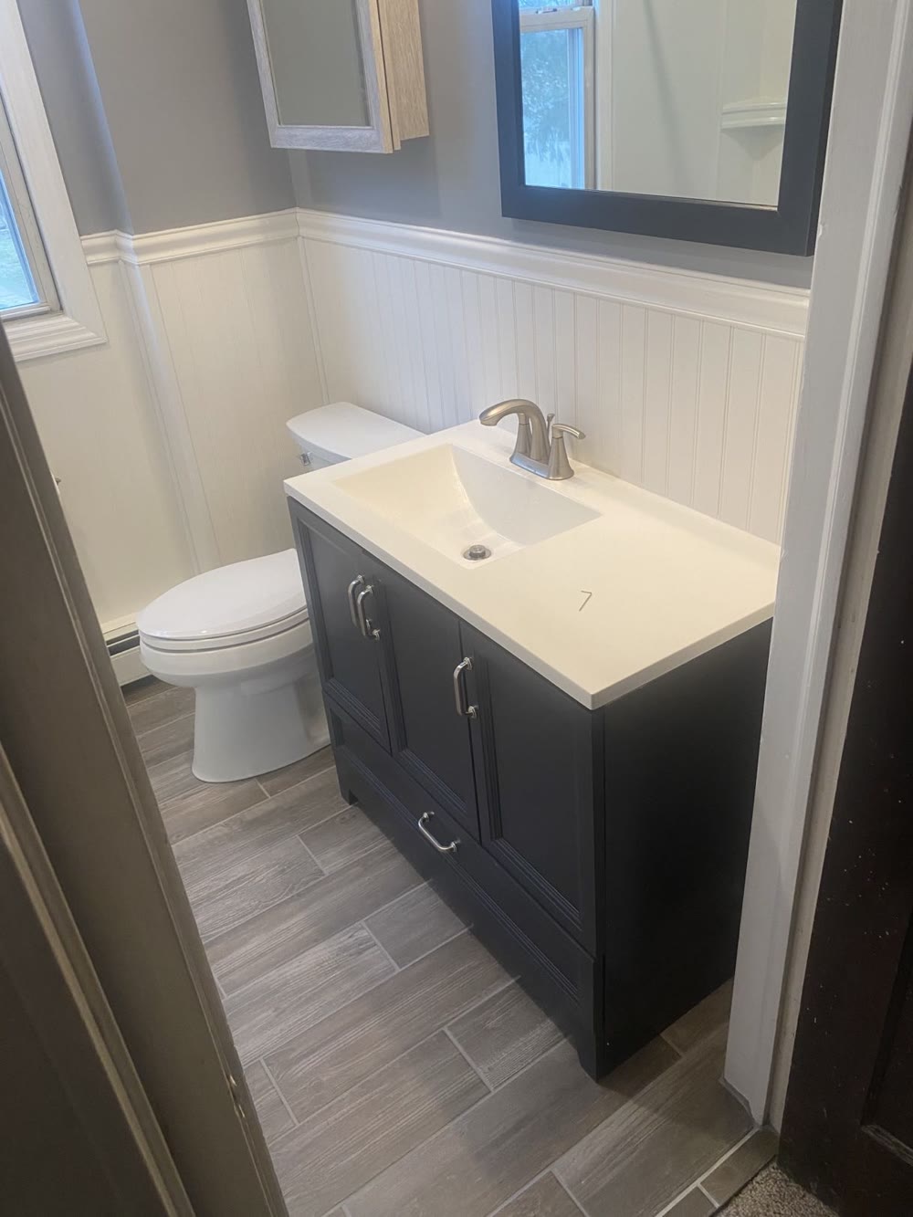 Bathroom vanity with framed mirror