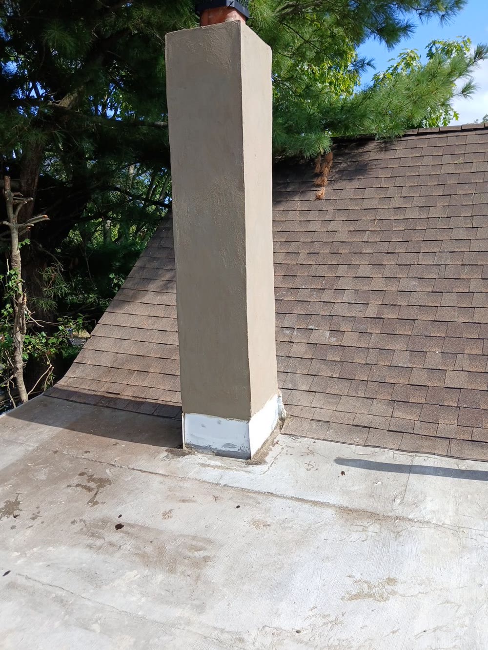 Repaired chimney with new stucco and flashing