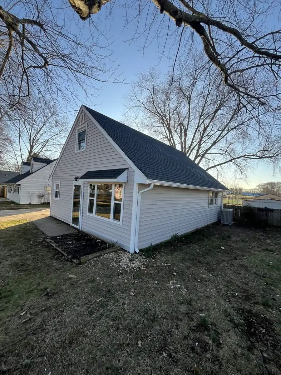 Completed Ewing exterior with light-colored siding, white trim and a dark shingle roof