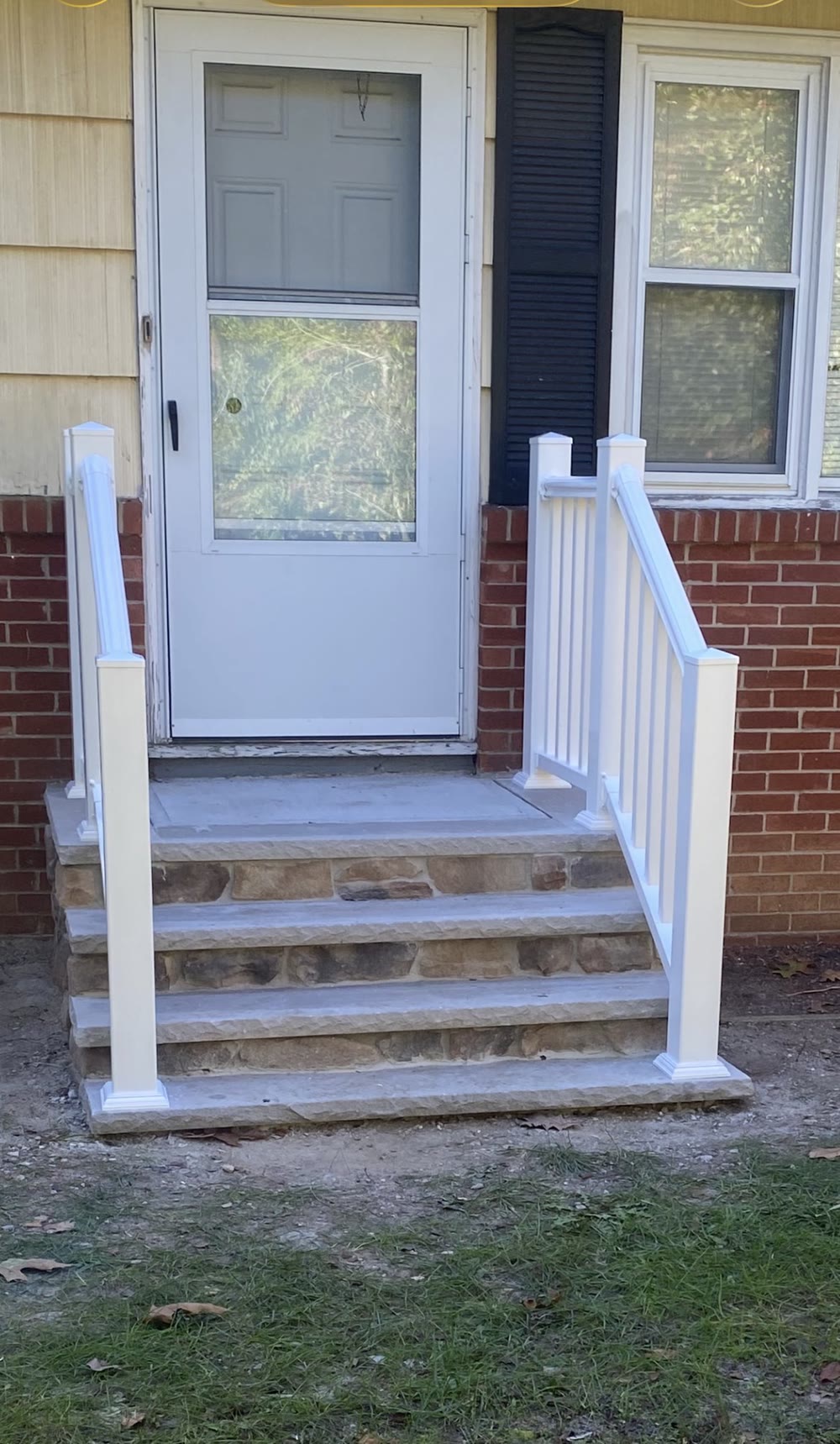 New stone steps with white vinyl railings